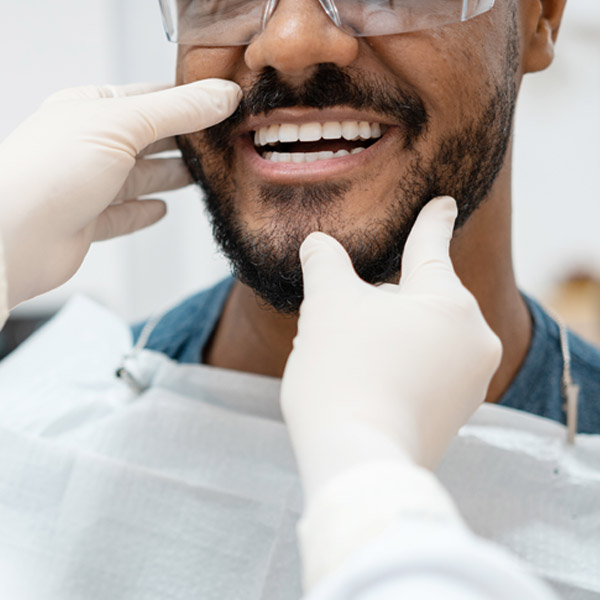 close up of man smiling with teeth showing